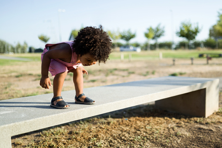 Portrait of a african american baby having fun in the park.の写真素材