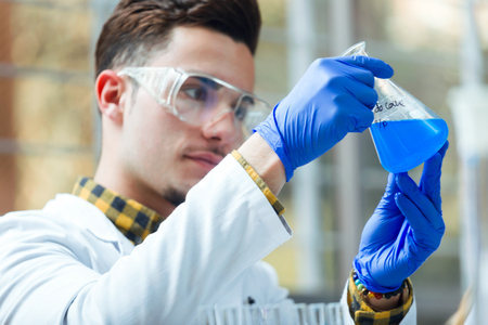 Portrait of concentrated scientist making experiment in laboratory.の写真素材