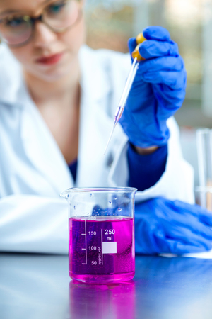 Portrait of concentrated scientist making experiment in laboratory.の写真素材