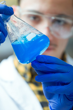 Portrait of concentrated scientist making experiment in laboratory.の写真素材