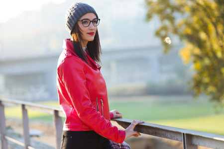 Portrait of beautiful young woman looking sideways in the city.の写真素材