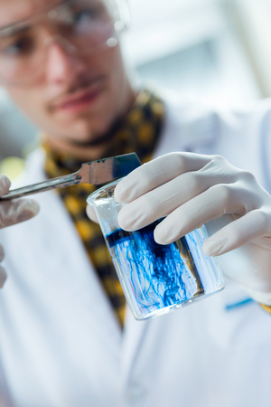 Portrait of concentrated scientist making experiment in laboratory.の写真素材