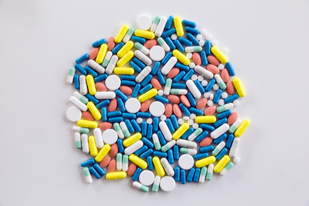 Portrait of assorted pharmaceutical medicine pills and capsules on the table.