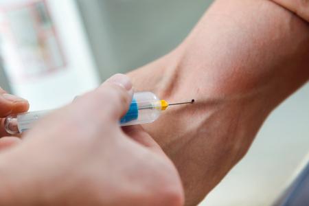 Portrait of medical technologist doing a blood draw services for patient.の写真素材