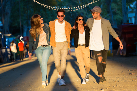 Shot of happy and attractive young group of friends enjoying time in eat market in the street.の写真素材