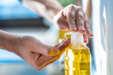 Close-up of man using liquid soap for a washing hands. Personal hygiene, health care and coronavirus prevention.の写真素材