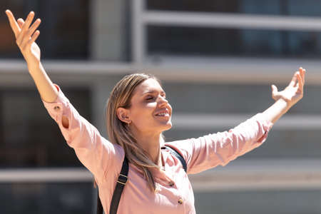 Shot of a beautiful blonde woman enjoying fresh air on the street.の写真素材