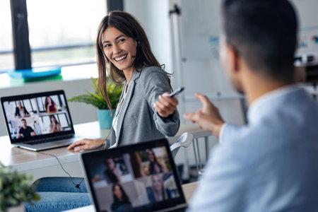 Shot of attractive smart business woman leaves a pen to her partner while doing a video call with...