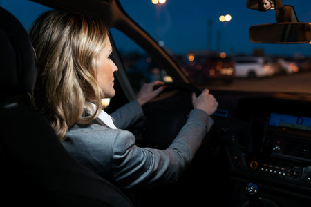 Shot of beautiful mature woman thinking while driving her car for the city at night.の写真素材