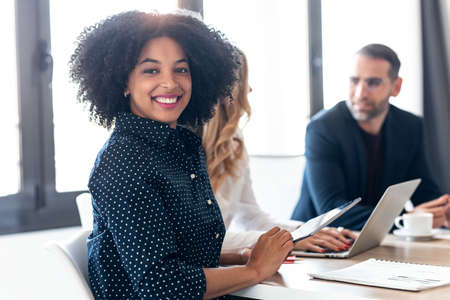 Shot of casual multiage business people working with laptops while talking of they new project together in modern startup.の写真素材