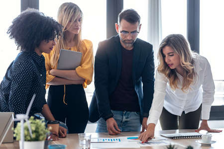 Shot of smart business team talking with colleagues in the meeting on coworking space.の写真素材
