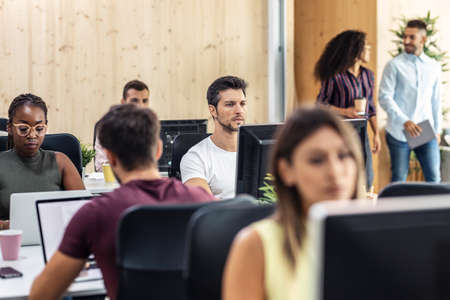 Shot of multiethnic businesspeople working with computers in a coworking place.の写真素材