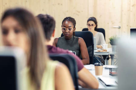 Shot of multiethnic businesspeople working with computers in a coworking place.の写真素材