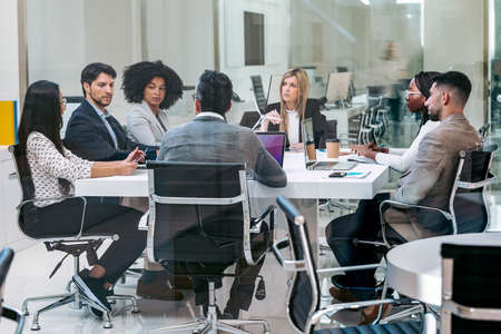 Shot of business people discussing together in conference room during meeting at office in a modern...