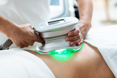 Shot of cosmetologist makes the procedure an ultrasonic cleaning of skin of a beautiful woman in the...