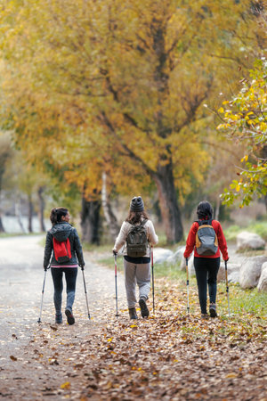 Shot of beautiful family hikers with backpack walking while looking at the landscape in the mountainの写真素材