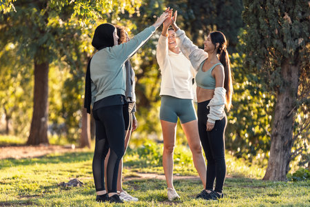 Shot of group of sporty friends celebrating after going for a runの写真素材