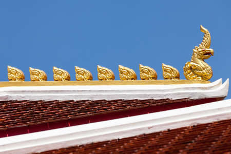 detail of ornately decorated temple roof in bangkok, thailand