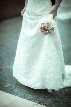 the bride holding the wedding bouquetの写真素材