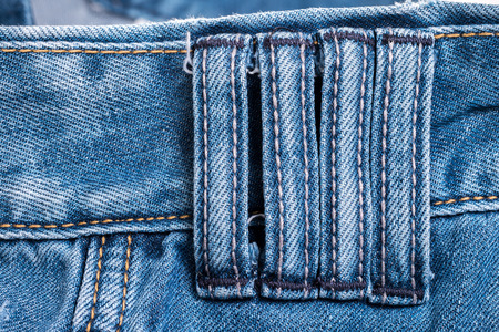 Close up detail four belt loops on blue jeansの写真素材