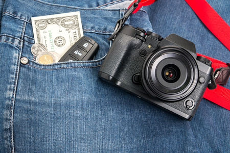 Retro digital camera and money on jeans backgroundの写真素材