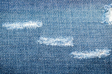 torn old blue jeans backgroundの写真素材