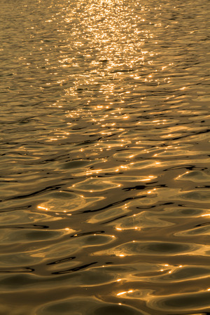 Gold water surface and sun light の写真素材