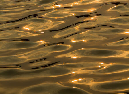 Gold water surface and sun light の写真素材