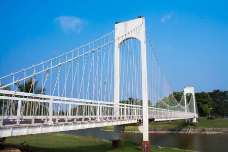 The metal rope bridge and a blue sky in the parkの写真素材