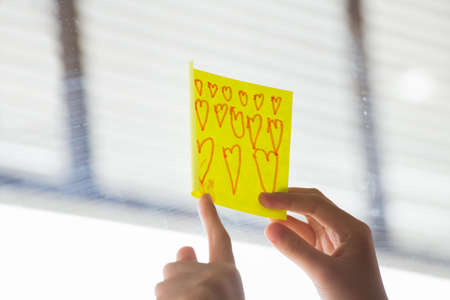 A girl paste the note on the mirror