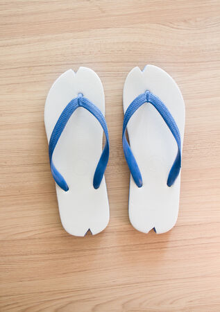 White slippers on the plywood backgroundの写真素材