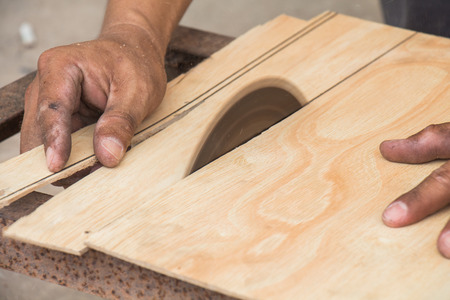 Carpenter using electrical saw for cutting woodの写真素材