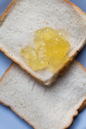 Slice of white toast topped with vibrant orangeの写真素材