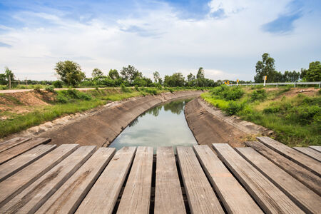 Old wooden bridge across the canalの写真素材