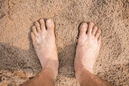 Bare human feet in the sandの写真素材
