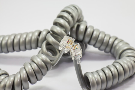 Spiral telephone cable isolated on whiteの写真素材