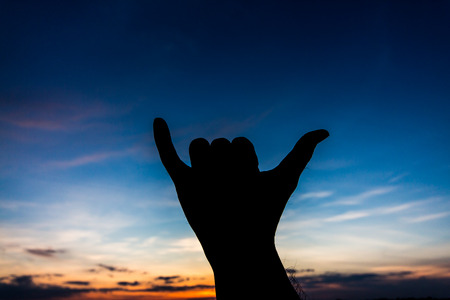 Rock sign hand silhouette in skyの写真素材
