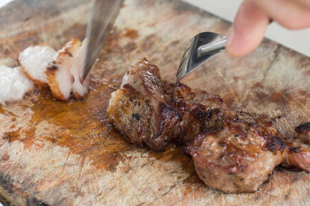 Were sliced roast pork Positioned on a wooden cutting boardの写真素材