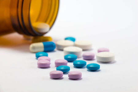 Diferent tablets pills heap mix on white isolated backgroundの写真素材
