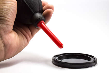 Cleanning the lens cover by blowerの写真素材