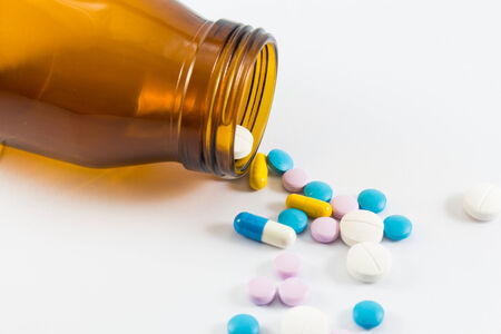 Diferent tablets pills heap mix on white isolated backgroundの写真素材