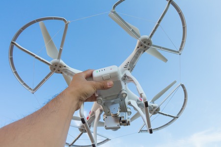 THAILAND UDONTHANI - Dec 24 , 2014 : Hand holding Drone flying helicopter with camera after use for top view new year partyの写真素材