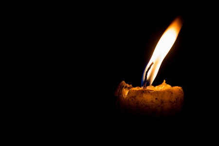 light of yellow candle at nightの写真素材