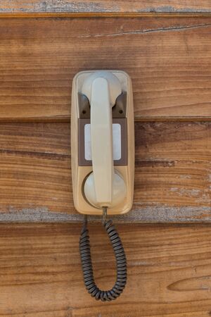 Retro telephone on wood wall