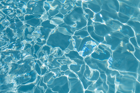 Pool water background with sun reflectionsの写真素材