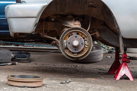 Repairing brake pads of old carの写真素材