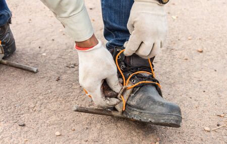 The workers were wearing safety shoes And equipment for climbing a electric pole.の写真素材