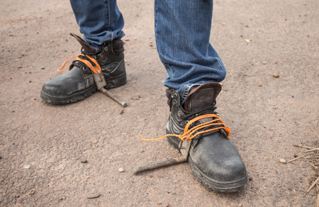 The workers were wearing safety shoes And equipment for climbing a electric pole.の写真素材