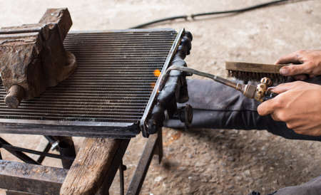 Technicians are welding for repair a leaking radiator.の写真素材