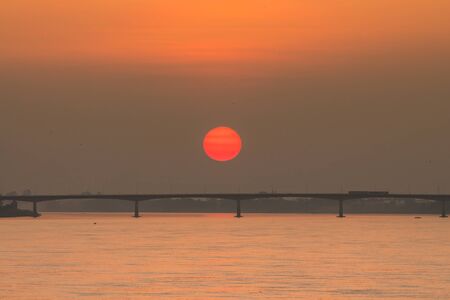 Sunset over the bridge across the Mekong River. Thai-Lao friendship bridge,の写真素材